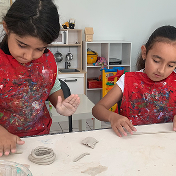 Children working with clay at Annar Daycare